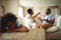 Sad girl listening to her parents arguing Royalty Free Stock Photo