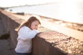 Sad girl with long hairs near river, childhood Royalty Free Stock Photo