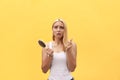 Sad girl looking at her damaged hair with comb in hand Royalty Free Stock Photo