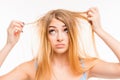 Sad girl looking at her damaged hair Royalty Free Stock Photo