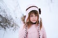 sad girl in the pink jacket gently freezing outside in the winter, snow, emotions concept