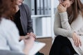 Sad girl with psychotherapist. Women`s issues support group concept