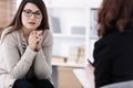 Sad girl with psychotherapist. Women`s issues support group concept