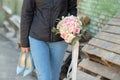 sad girl sits on a bench and holds a wedding bouquet. girl crying. broken love