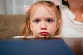 sad girl sits leaning on chin against table and waiting for order in cafe. Royalty Free Stock Photo