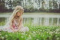 Sad girl sitting alone in the grass by the river Royalty Free Stock Photo