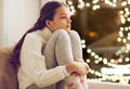 Sad girl sitting at home window on christmas Royalty Free Stock Photo