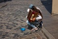 Sad girl street musician playing small accordion