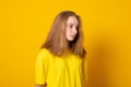 Sad girl teenager in yellow t-shirt. Cute upset girl is sad Royalty Free Stock Photo