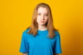 Sad girl teenager in yellow t-shirt. Cute upset girl Royalty Free Stock Photo