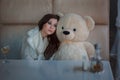 Sad girl with toy bear. Royalty Free Stock Photo