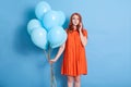 Sad girl wearing dress and using Smart phone for calling to her guests, waiting them for party, looks sad, friends ignoring her, Royalty Free Stock Photo