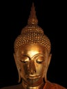 The sad gold buddha statue face on the black background Royalty Free Stock Photo