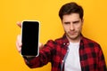 Sad guy holding showing empty smartphone screen Royalty Free Stock Photo
