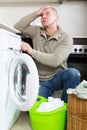 Sad guy using washing machine Royalty Free Stock Photo