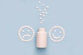 A sad and a happy face made of pills.   A bottle of antidepressants Royalty Free Stock Photo