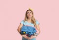 Sad housewife blowing lips, looks up and holds clothes Royalty Free Stock Photo