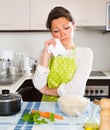 Sad housewife cooking dinner Royalty Free Stock Photo