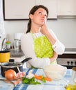 Sad housewife cooking dinner Royalty Free Stock Photo