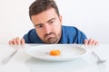 Depressed man dieting and eating only vegetables Royalty Free Stock Photo
