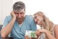 Sad husband give 100 euros to golddigger wife