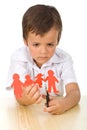 Sad kid cutting up paper people family Royalty Free Stock Photo
