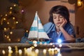 Sad kid looking at toy vessel Royalty Free Stock Photo