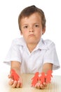 Sad kid with paper people in hands Royalty Free Stock Photo