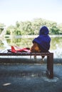 Sad kid sitting alone with dog and toy airplane on bench by the river bank. Diagnosing Early-Onset Childhood depression