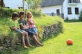 Sad kids on stone wall Royalty Free Stock Photo