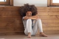 Sad little african girl sitting on floor feels lonely Royalty Free Stock Photo