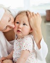 Sad little baby girl comforted by her mother