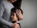 Sad little boy being hugged by his mother at home. Royalty Free Stock Photo