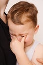 Sad little boy is crying. Toddler child has stress, pain and is tired. Mother comforting her crying boy. Royalty Free Stock Photo