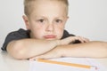 Sad little boy doing his homework Royalty Free Stock Photo