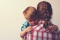 Sad little boy hugging his mother at home Royalty Free Stock Photo