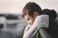 Sad little boy leaning over railing Royalty Free Stock Photo