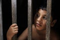 Sad little boy look from window. Portrait of a sad innocent child looking out the window.