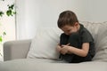 Sad little boy on sofa