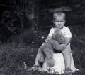 Sad little boy with teddy bear black and white