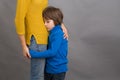 Sad little child, boy, hugging his mother at home, isolated image Royalty Free Stock Photo