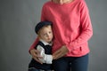 Sad little child, boy, hugging his mother at home, isolated image, copy space Royalty Free Stock Photo