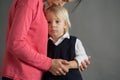 Sad little child, boy, hugging his mother at home, isolated image, copy space Royalty Free Stock Photo