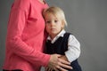 Sad little child, boy, hugging his mother at home, isolated image, copy space Royalty Free Stock Photo