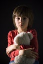 Sad little child, crying, hugging stuffed toy Royalty Free Stock Photo