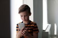 Sad little child with smartphone. Danger of internet Royalty Free Stock Photo