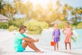 Sad little kids waiting for their dad working with laptop to swim and have fun on the beach Royalty Free Stock Photo