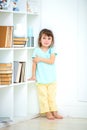 A sad little delinquent girl stands punished in the corner. Wines and punishment of children Royalty Free Stock Photo