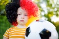 Sad little german child crying over her national football team's loss