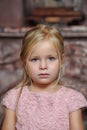 Sad little girl blonde in pink dress Royalty Free Stock Photo